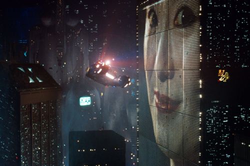 A "spinner" flies through the futuristic world depicted in Blade Runner.