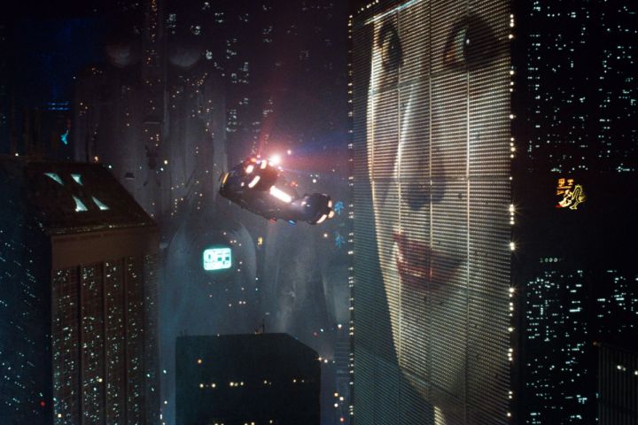 A "spinner" flies through the futuristic world depicted in Blade Runner.