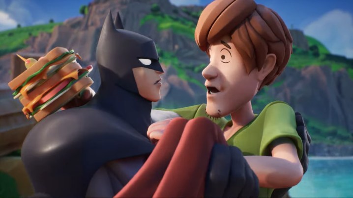 Batman is holding Shaggy.