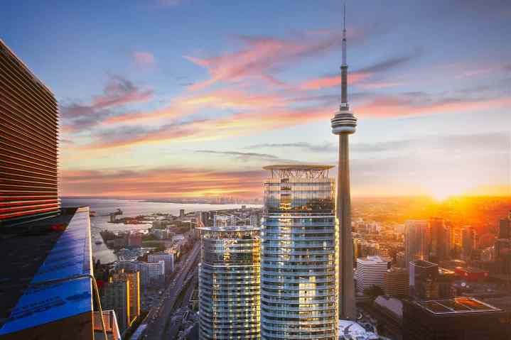 Toronto skyline with buildings and C.N. tower against a sunset.