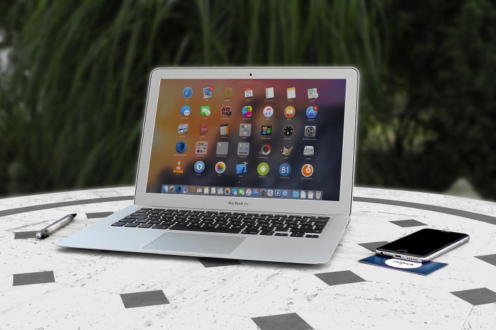 MacBook Air on a patio table, outdoor office.