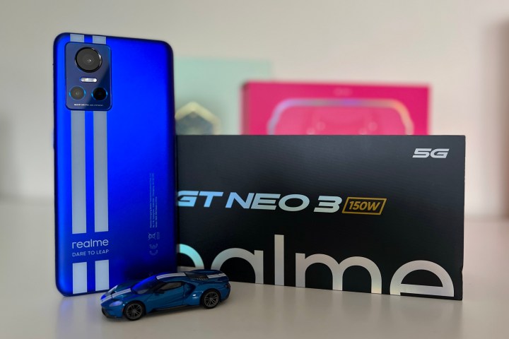 Realme GT Neo 3 standing next to its box.