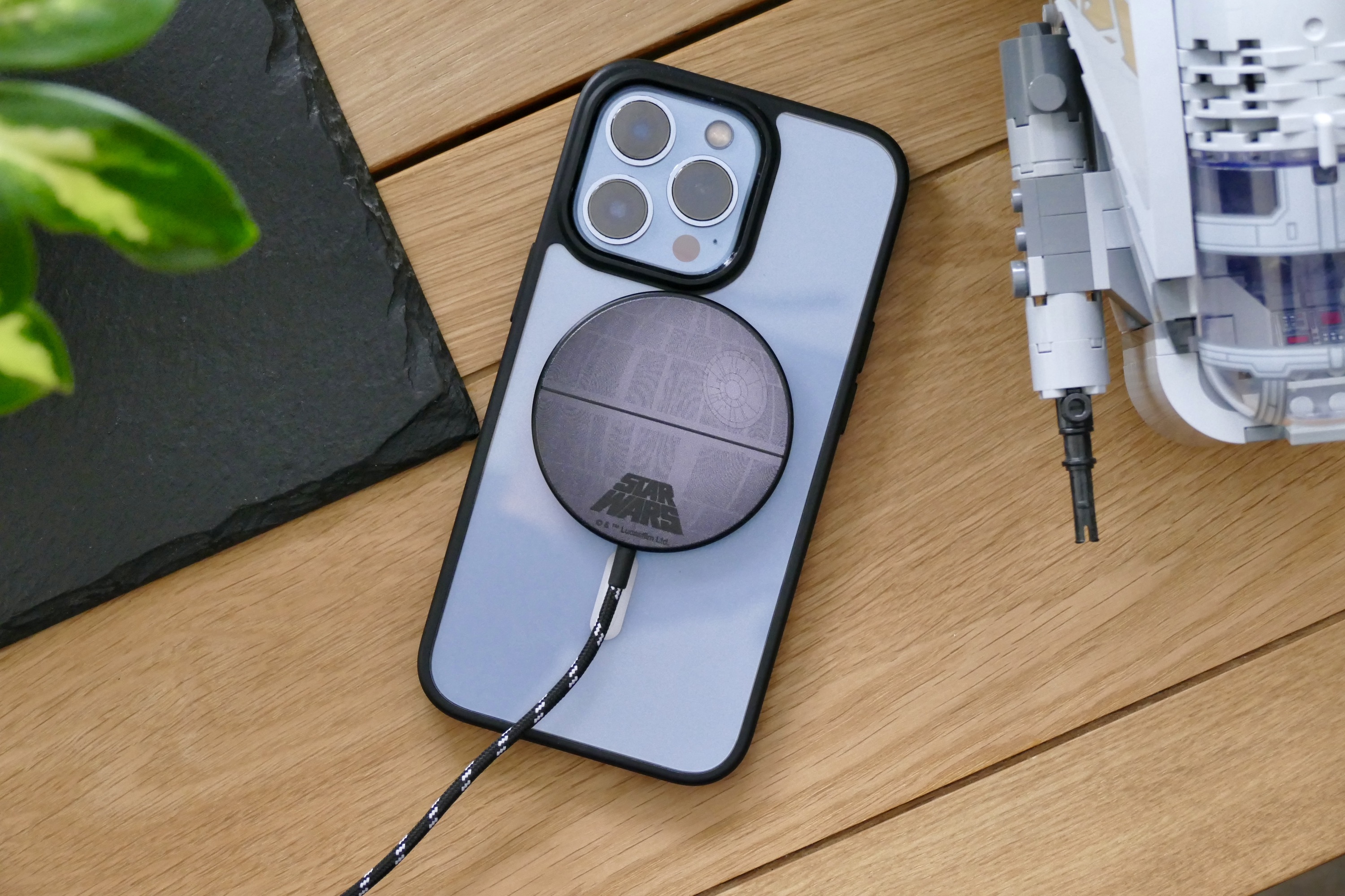 Casetify's Death Star magnetic charger on the back of an iPhone 13 Pro.
