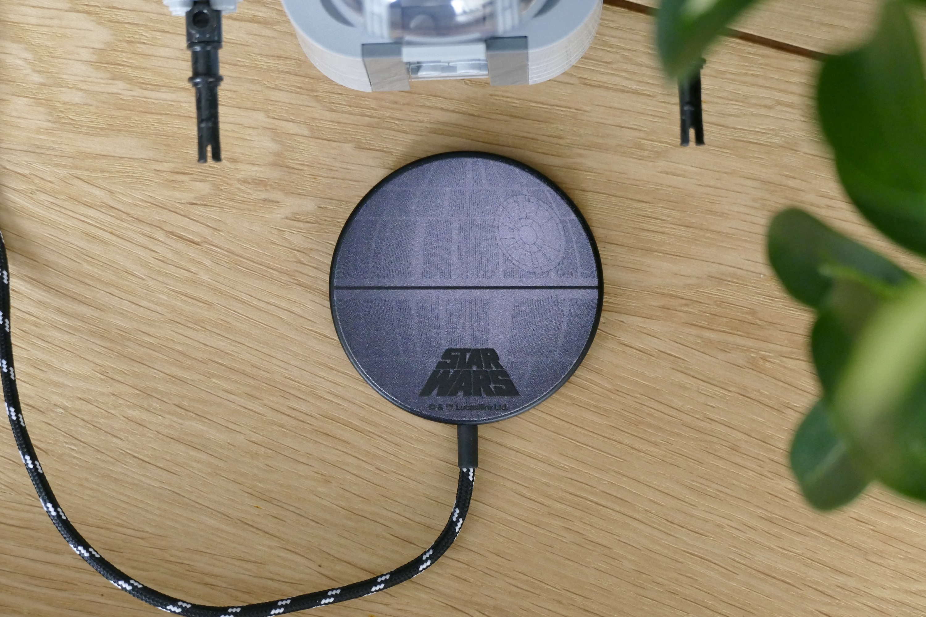 Casetify's Death Star magnetic wireless charger sitting on a desk.