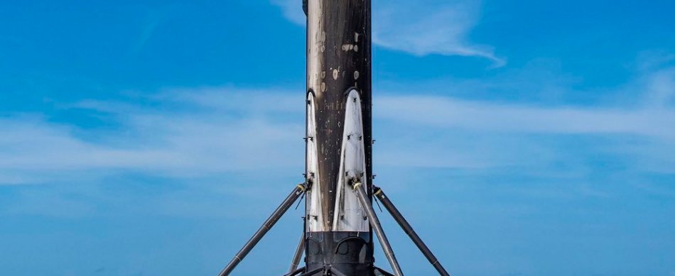 SpaceX engineers inspect a SpaceX Falcon 9 booster shortly after it landed at Cape Canaveral.