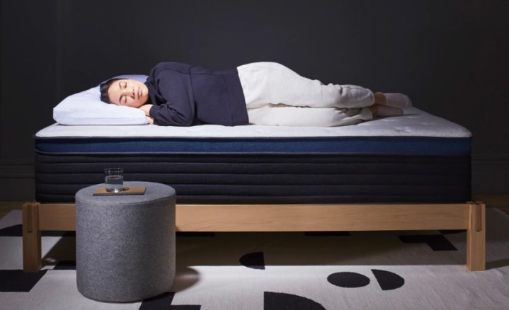 This is a model sleeping on a Helix mattress.