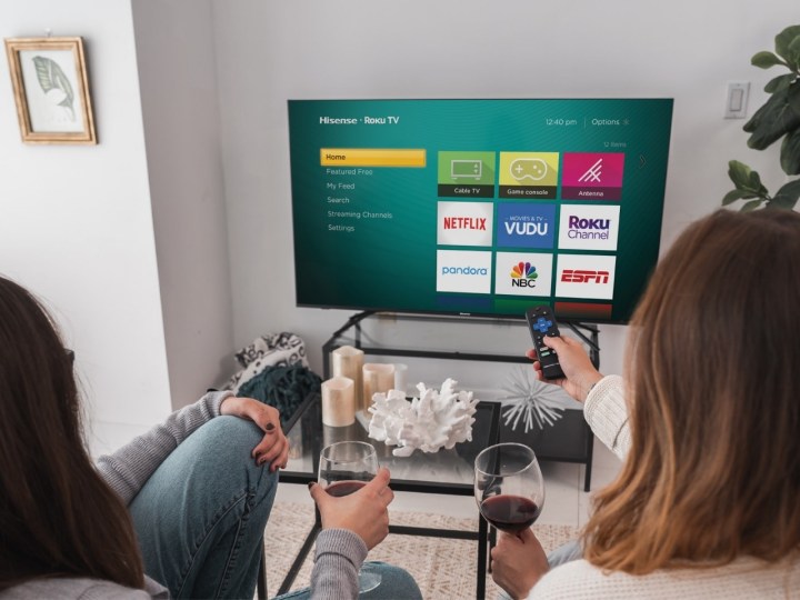 Hisense R6 Series 4K TV with remotes pointed at it.