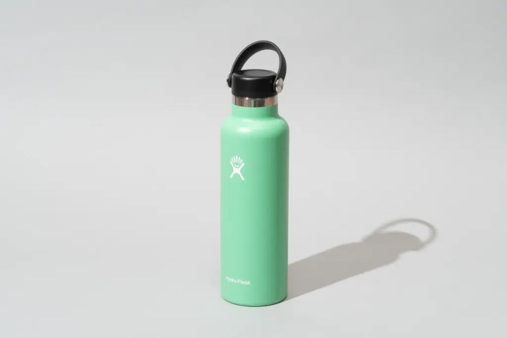 A mint green Hydro Flash water bottle on a gray background.