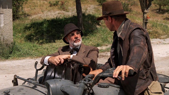 Sean Connery and Harrison ford share a motorcycle. 
