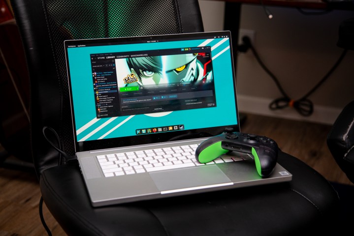 A laptop running Linux with a controller sitting on it.