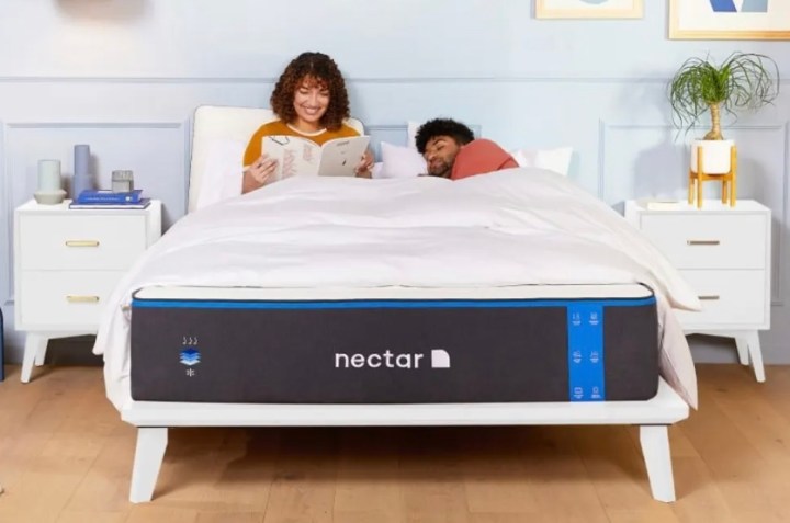 A couple rests on a Nectar Memory Foam mattress in a bedroom.