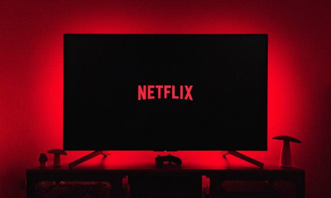 The Netflix logo is displayed on a TV screen while red lights illuminate the wall behind.