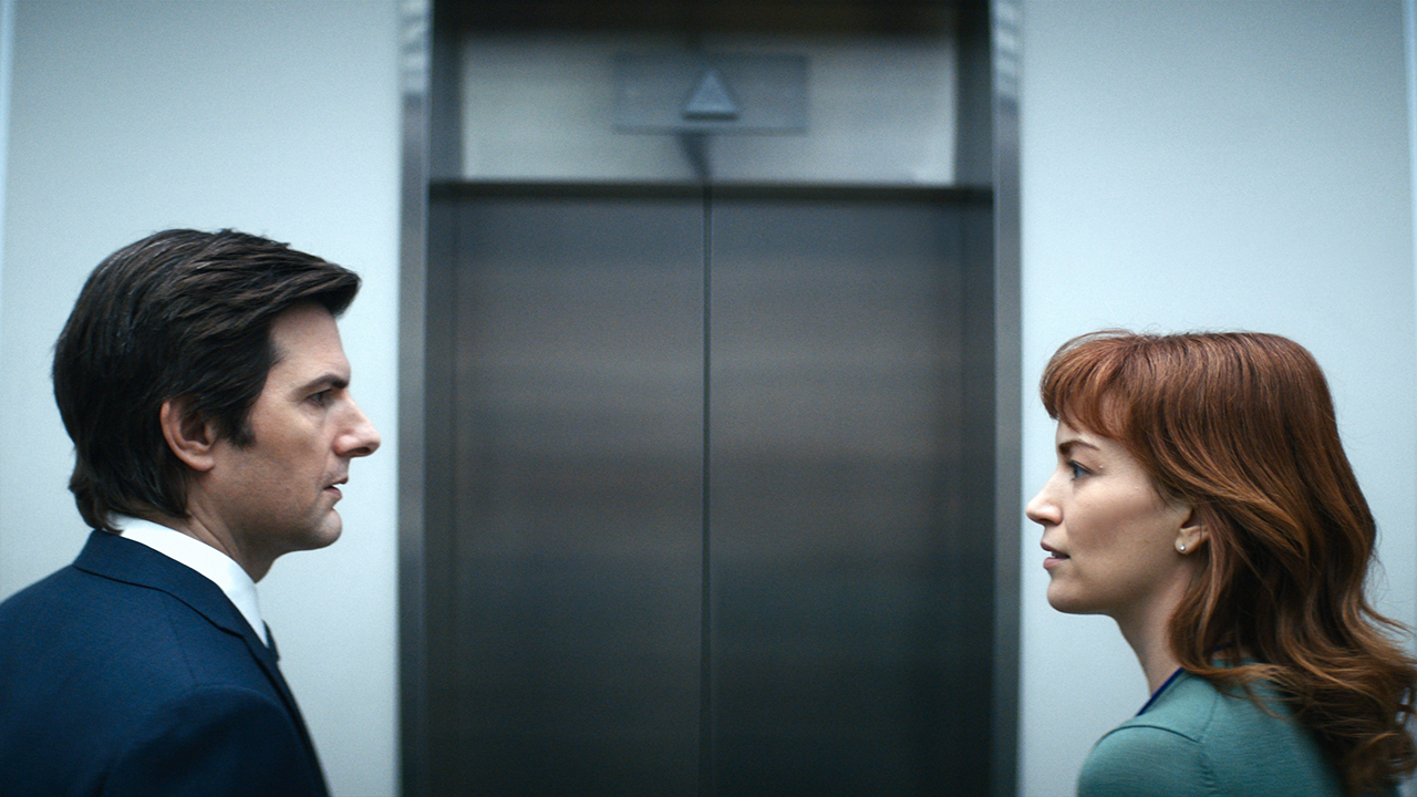 Mark and Helly looking at one another in front of the elevator at work in Apple TV+ series Severance.