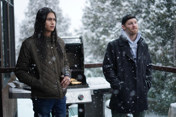 Harlan Blayne Kytwayhat and Jared Keeso stand on a backyard deck in the winter in a scene from Shoresy.