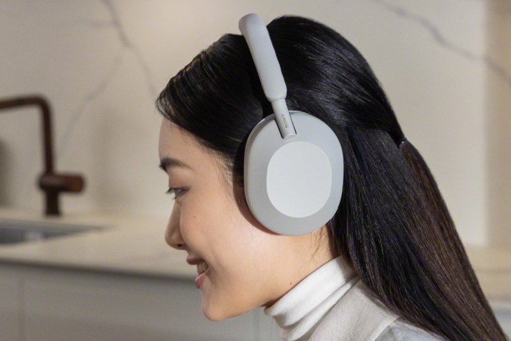 Woman with Sony WH-1000XM5 headphones.