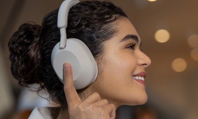 Woman wearing Sony WH-1000XM5 headphones.
