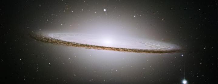  NASA's Hubble Space Telescope has trained its razor-sharp eye on one of the universe's most stately and photogenic galaxies, the Sombrero galaxy, Messier 104 (M104). The galaxy's hallmark is a brilliant white, bulbous core encircled by the thick dust lanes comprising the spiral structure of the galaxy. As seen from Earth, the galaxy is tilted nearly edge-on. We view it from just six degrees north of its equatorial plane. This brilliant galaxy was named the Sombrero because of its resemblance to the broad rim and high-topped Mexican hat.
