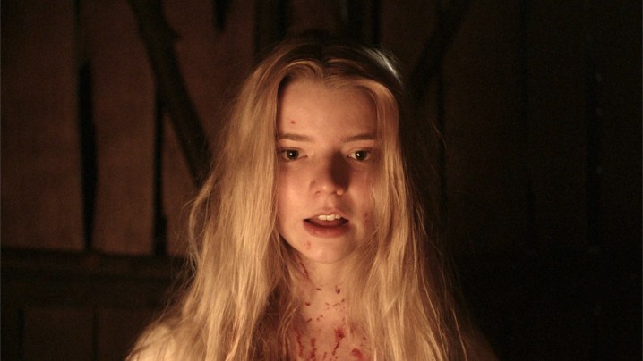 Thomasin looking at the camera with a satisfied expresion on her face in The Witch.