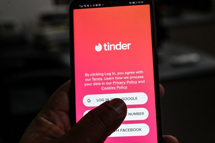 A user checks the dating app Tinder on a mobile phone.