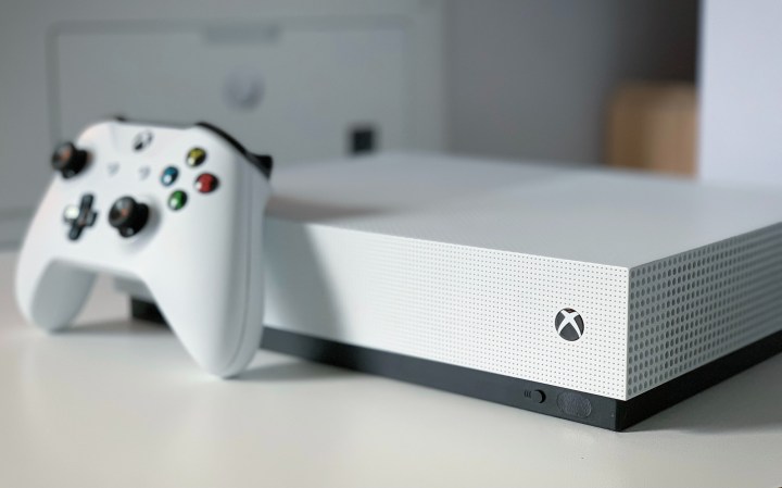 Xbox Series S placed on a white table with the controller just in front of it