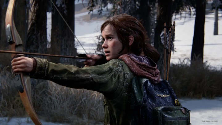 Ellie draws back a bow in a The Last of Us Part 1 screenshot.