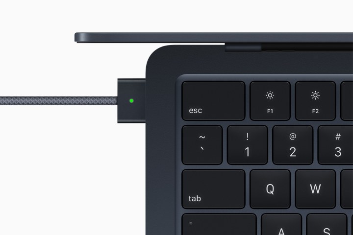 A top view of the M2 MacBook Air showing its keyboard and MagSafe charger.
