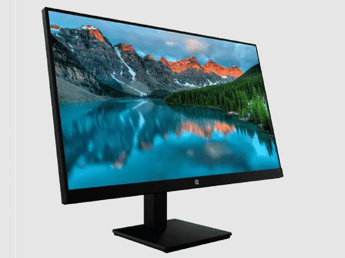 The HP X32 QHD Gaming Monitor with a serene landscape on the display.