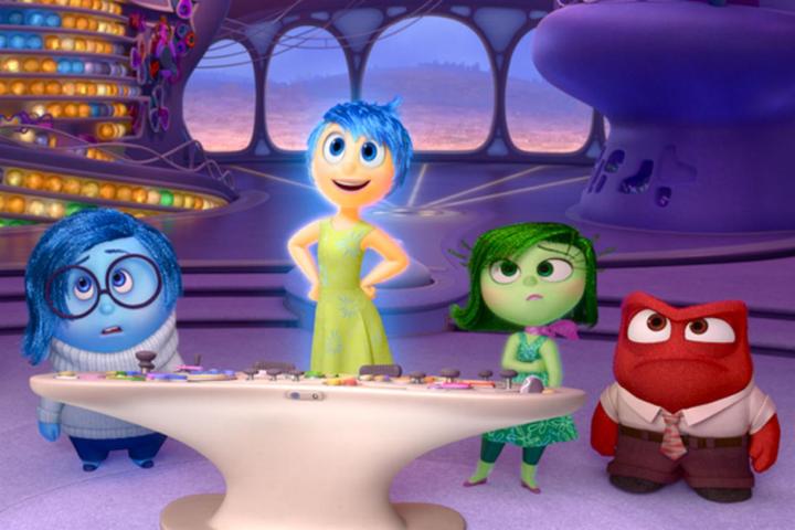 Joy, Sadness, Disgust, and Anger stare into camera in a scene from the Pixar film Inside Out