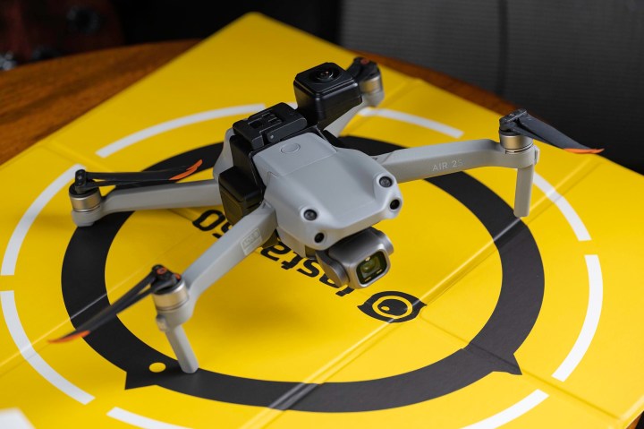 The Insta360 Sphere attached to the DJI Air 2S on a landing pad.