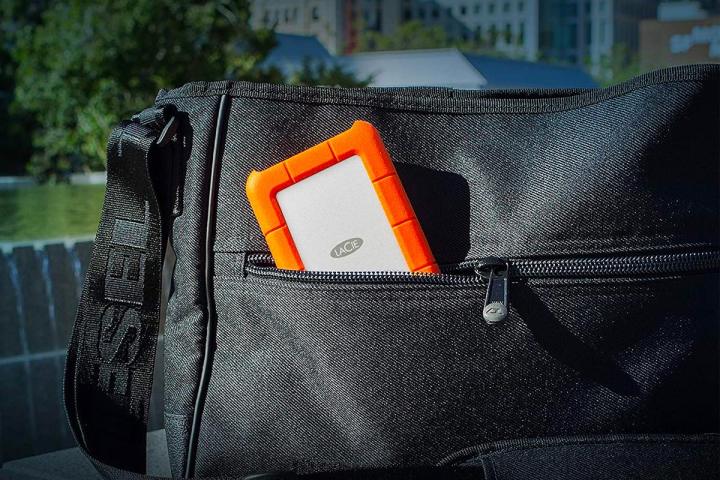 A LaCie Rugged Mini external hard drive tucked into a travel bag.