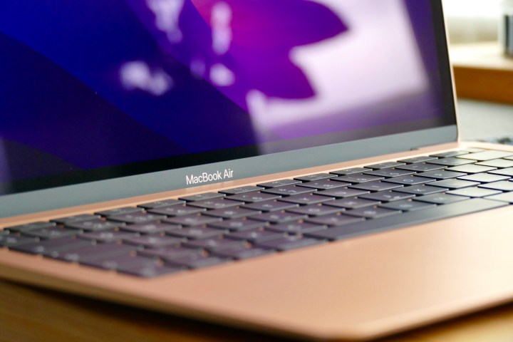 The gold MacBook Air M1's logo and keyboard.