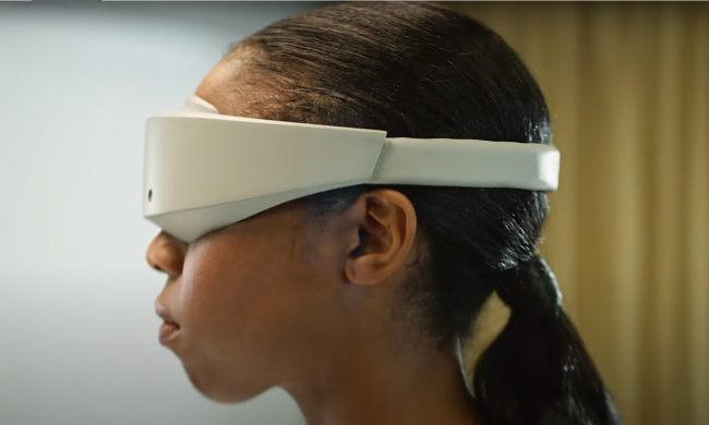 Someone wearing a futuristic VR headset.