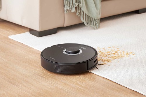 The Roborock Q7 Max+ in action cleaning crumbs off of carpet.