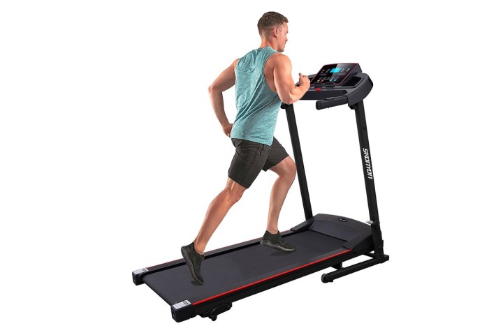 A man runs on the Skonyon folding treadmill.