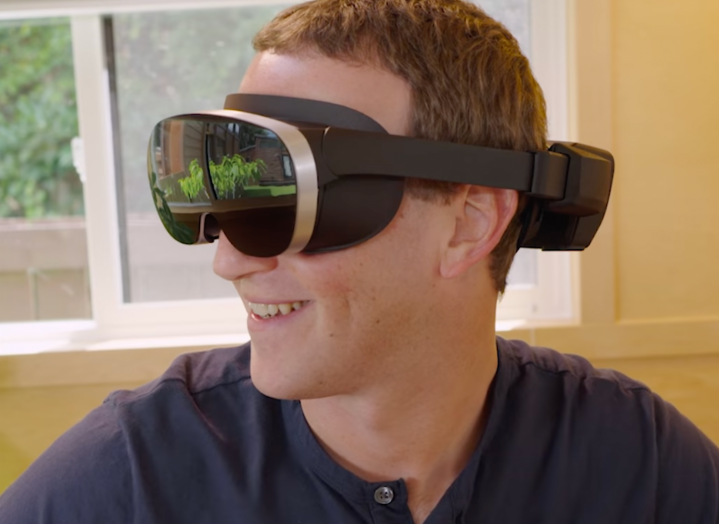 Mark Zuckerberg wears a prototype VR headset.