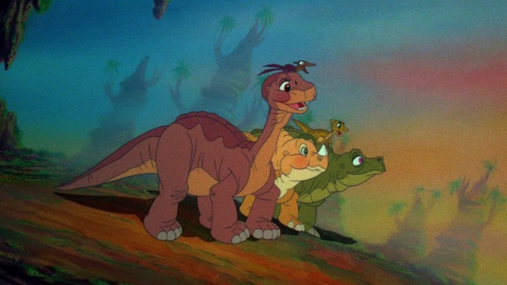 Littlefoot and his friends smiling as they journey together in The Land Before Time.