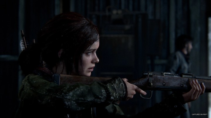 Ellie taking aim with a rifle.
