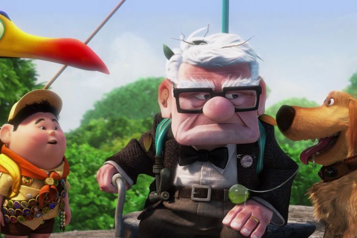 Russell, Dug, and Kevin stand around Carl Fredricksen in a scene from the Pixar film Up