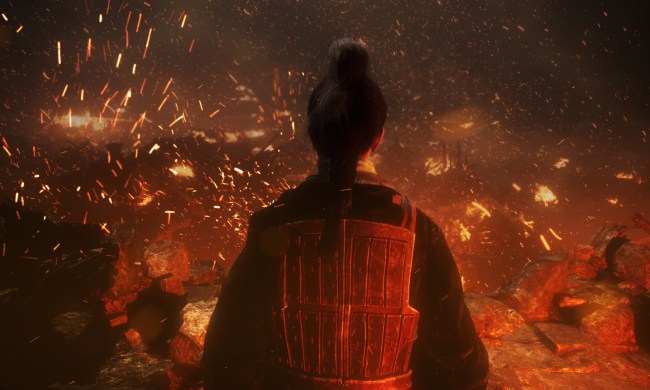 A soldier in red looks over a burning village.