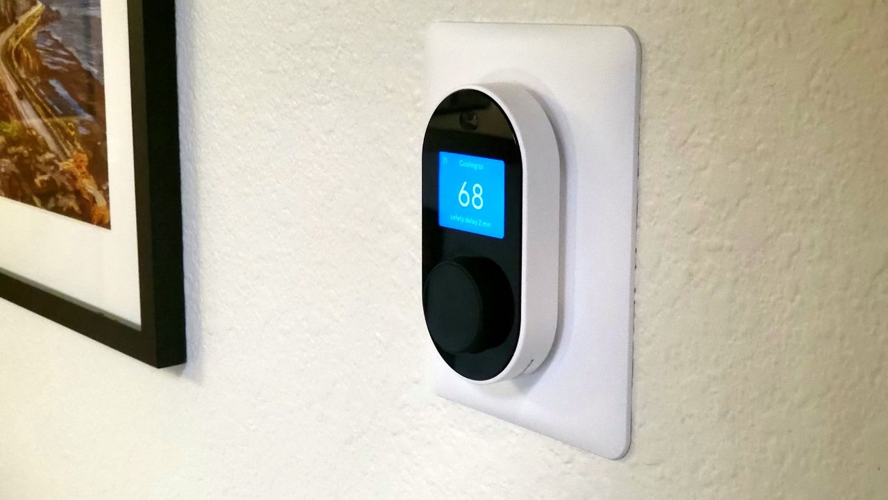 Wyze Thermostat installed on a white wall.