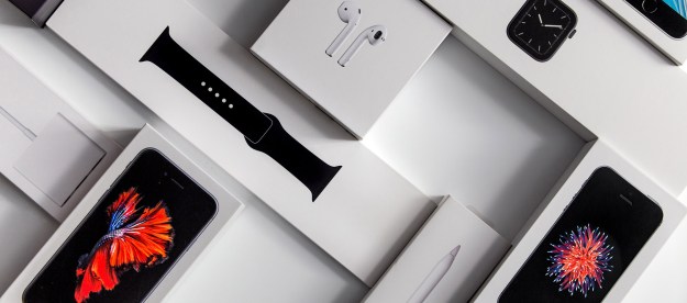 Boxes for an Apple Watch, iPhones, and Airpods sit on a desk.