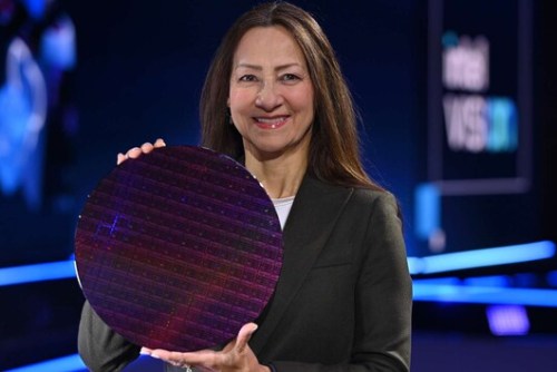 Sandra Rivera smiles as she holds an Intel Sapphire Rapids wafer.