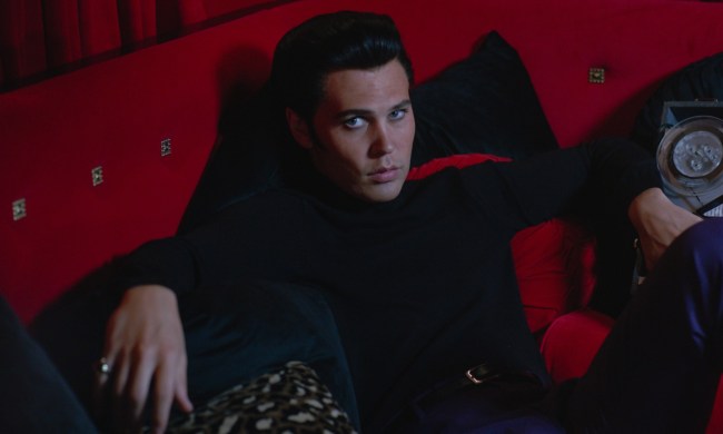 Austin Butler lounges on a red couch in Elvis.