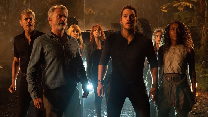 The cast of Jurassic World: Dominion stares up at an approaching dinosaur.
