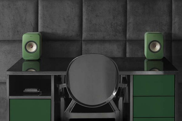 Green kef lsx wireless speakers on a desktop