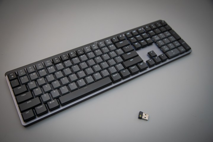 Logitech MX Mechanical keyboard sitting next to its dongle.