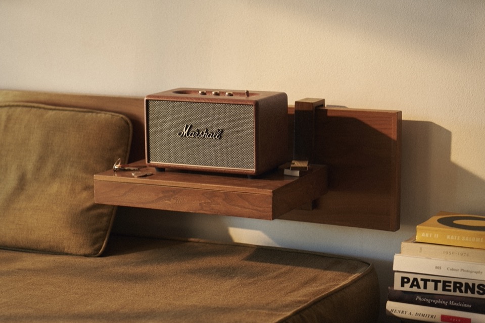 The Marshall third-gen home speaker sitting on a bedside table