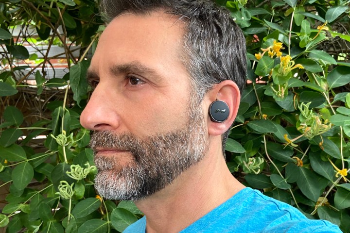 Man wearing NuraTrue Pro earbuds.