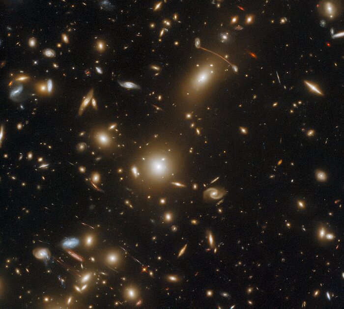 This galaxy cluster is so massive it warps space-time