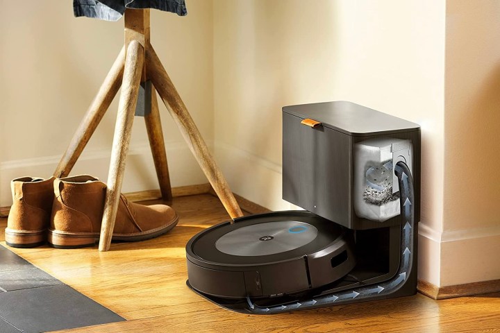 The iRobot Roomba j7+ on its charging dock and dirt disposal tank.